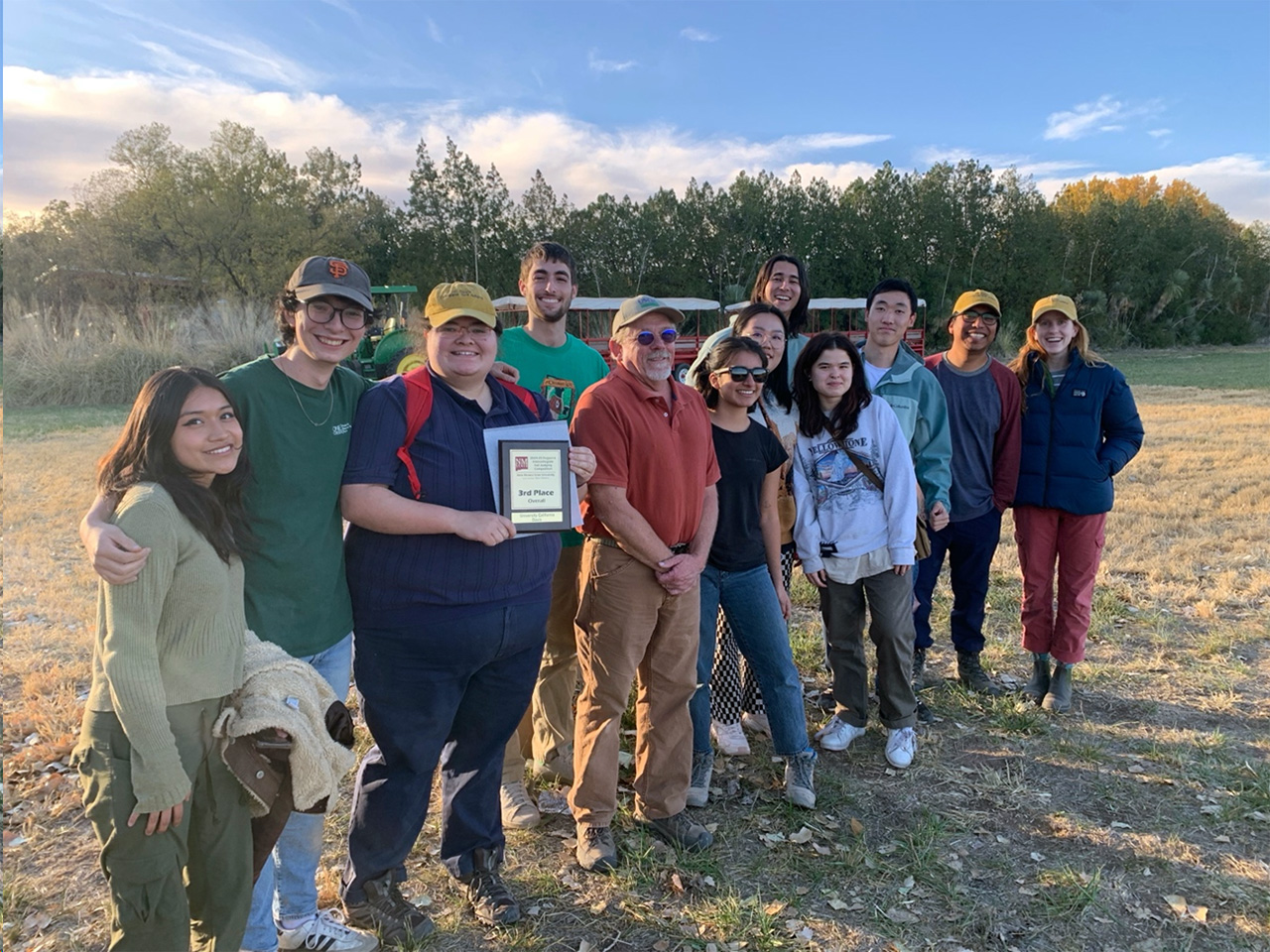 UCD team celebrating their big win! From left to right, soil judging team members are: Sandra Villegas, Patric Murphy, Gabe Reeb, Zach Orlando-Milbauer, NM State Soil Scientist Richard Strait, Jessica Martinez Aguilar, Weiqian Liu, Max Adams, Linh Le, Xincheng Yu and coaches Adolfo Coyotl and Ava-Rose Beech.